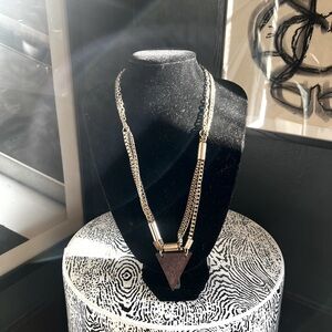 Layered gold and wood necklace.